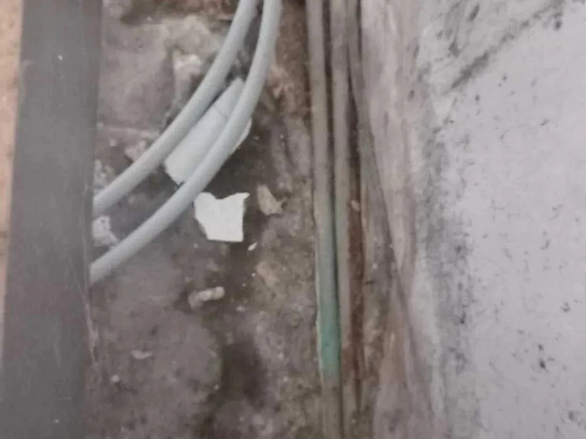 Corroded pipes exposed in a channel in the concrete floor